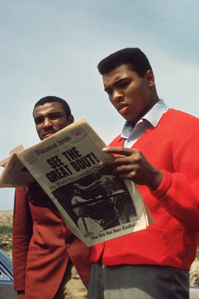 Muhammad Ali reads about his boxing match in the paper circa 1960's. Focus on Sport/Getty Images